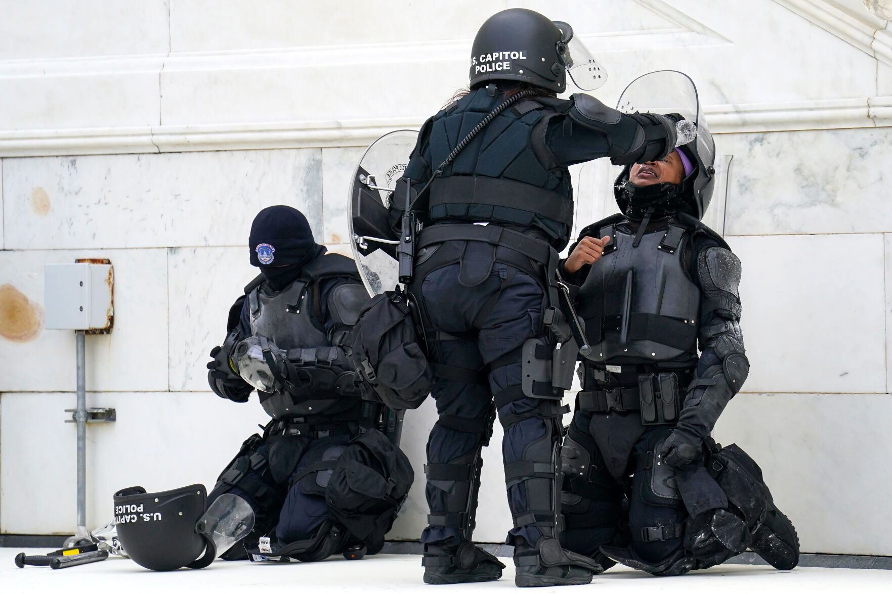A police officer has eyes flushed with water